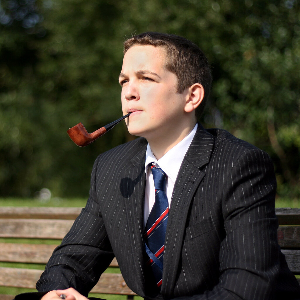 Photo of a young man smoking a pipe