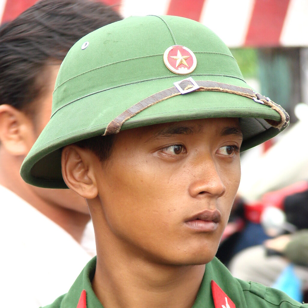 Photo of a young man wearing a pith helmet