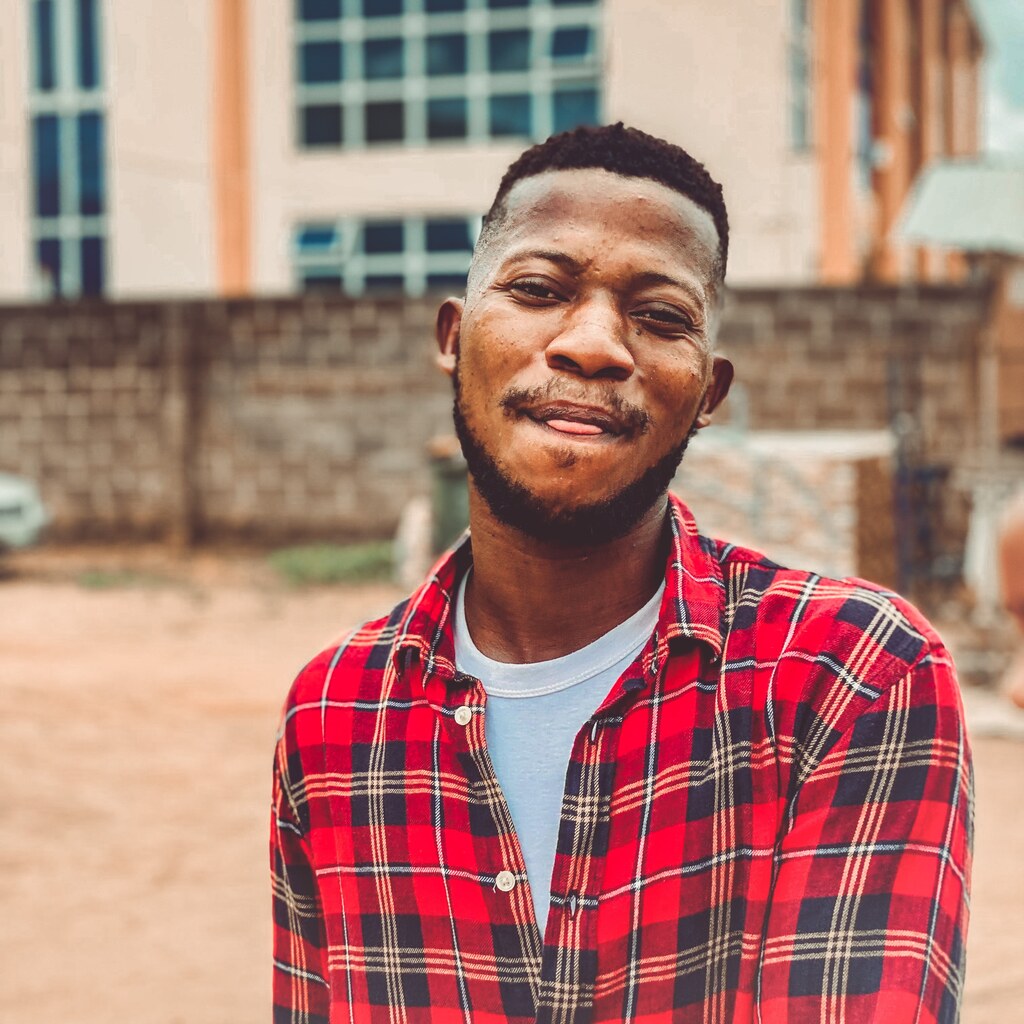 Photo of a man wearing a plaid shirt