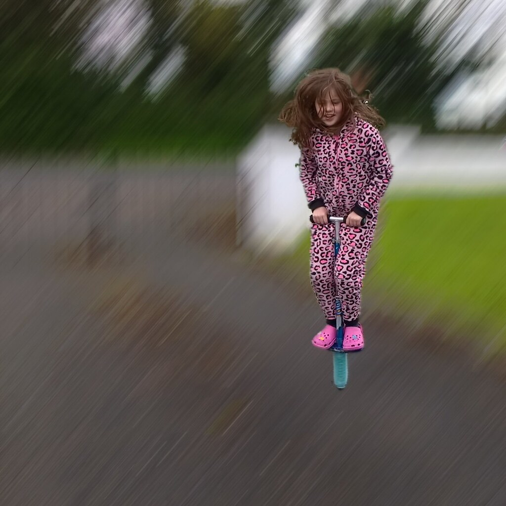 A girl using a pogo stick.