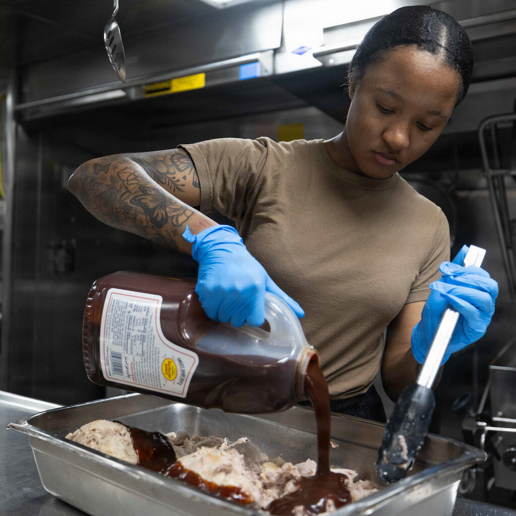 Photo of someone pouring barbeque sauce