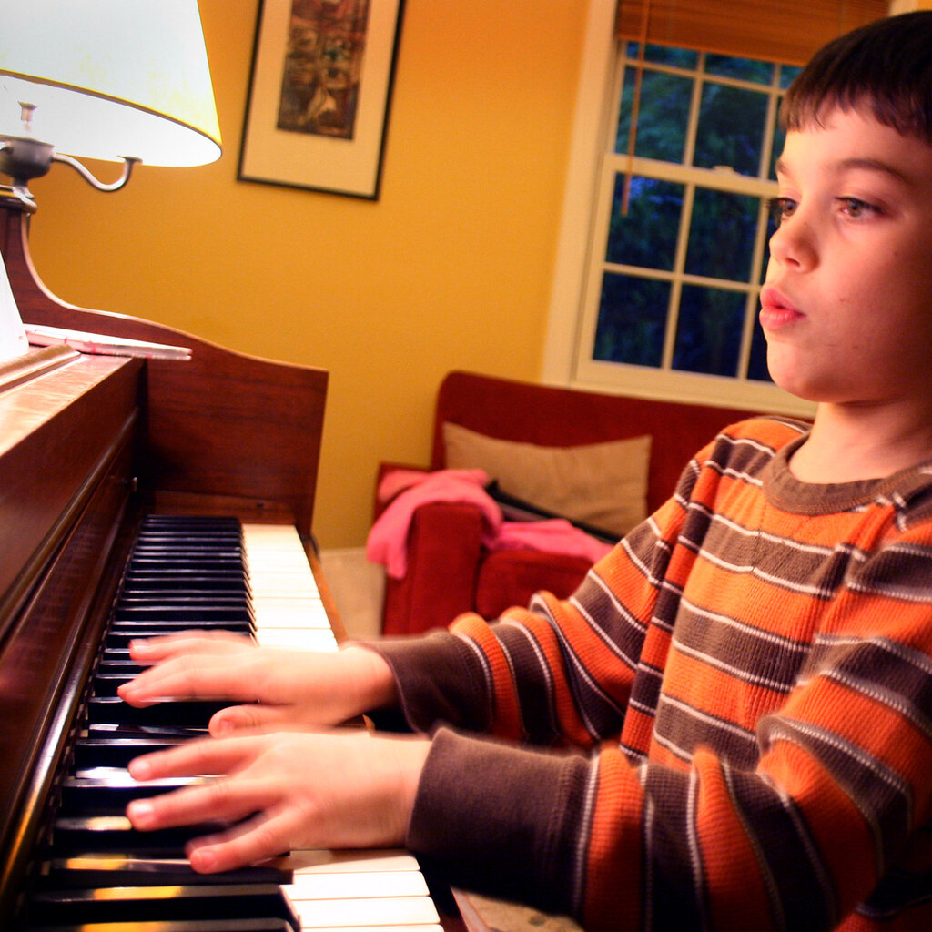 Photo of a boy practicing piano
