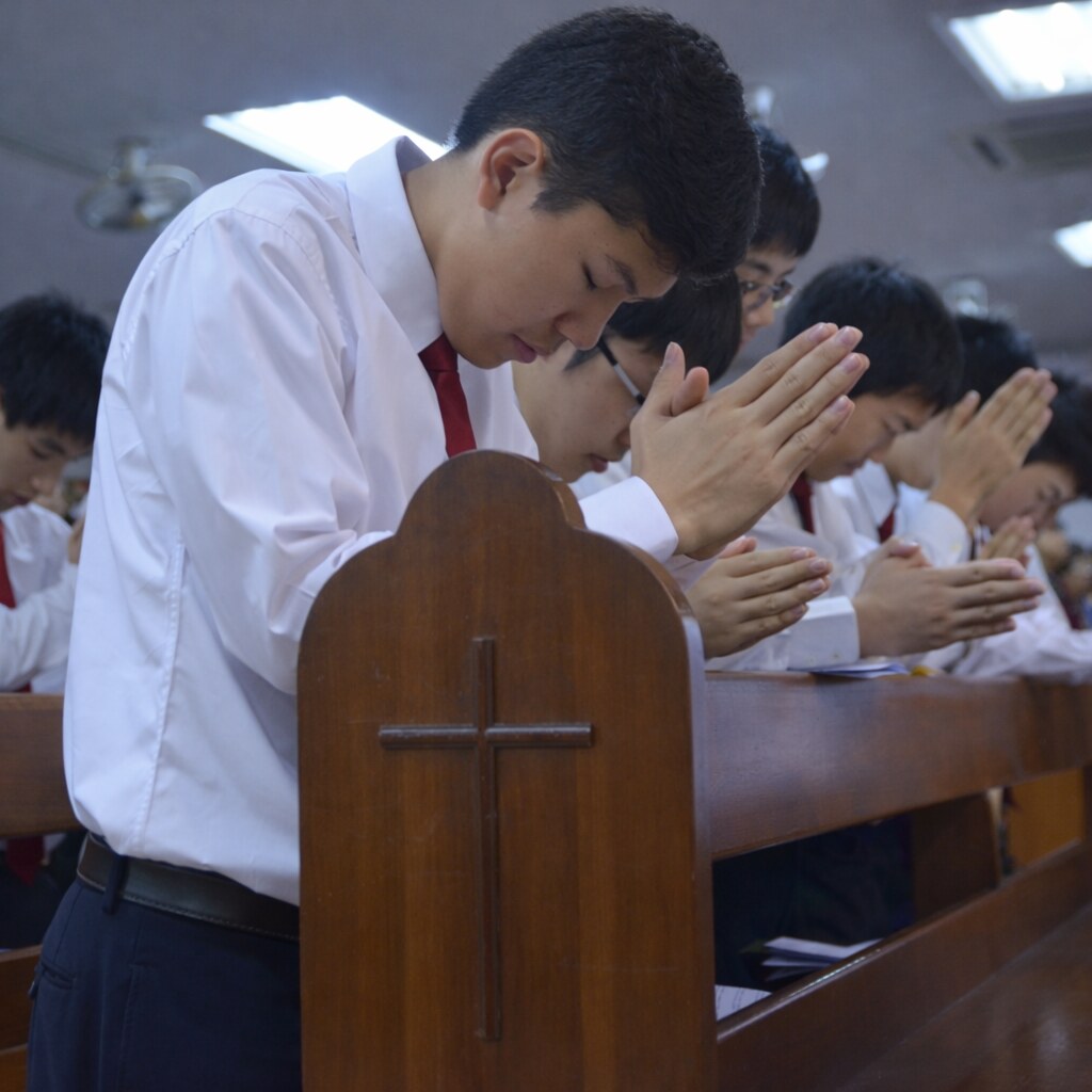 Photo of young men praying