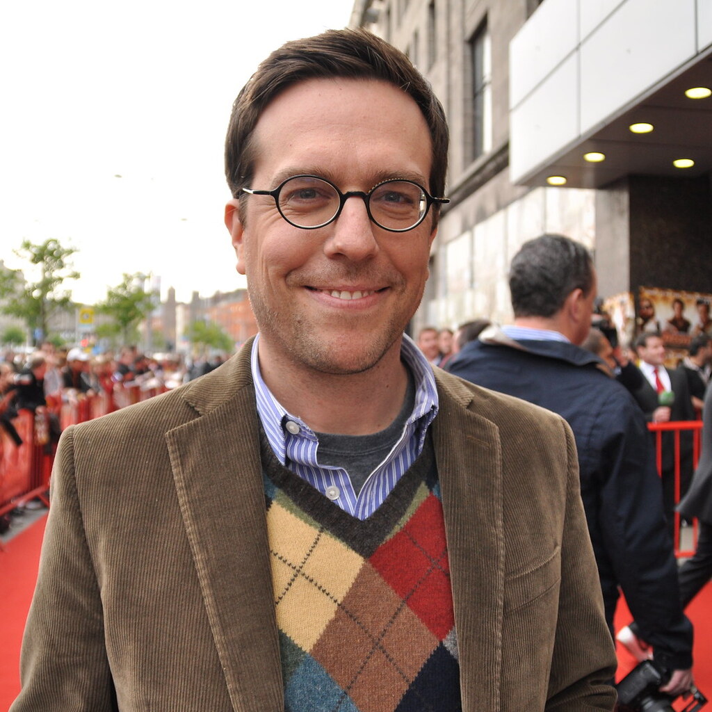 Actor Ed Helms standing on the red carpet at a movie premiere.