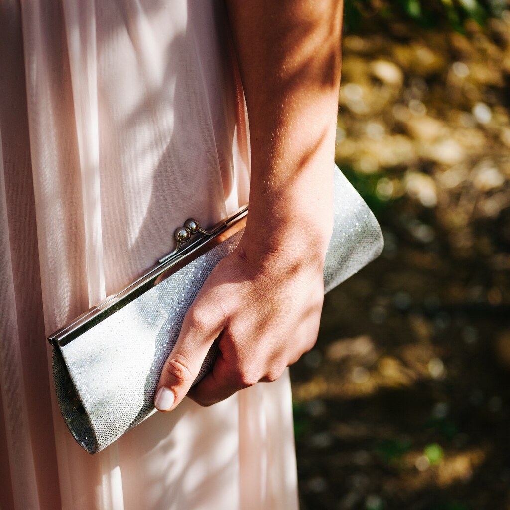 Photo of a woman holding a purse