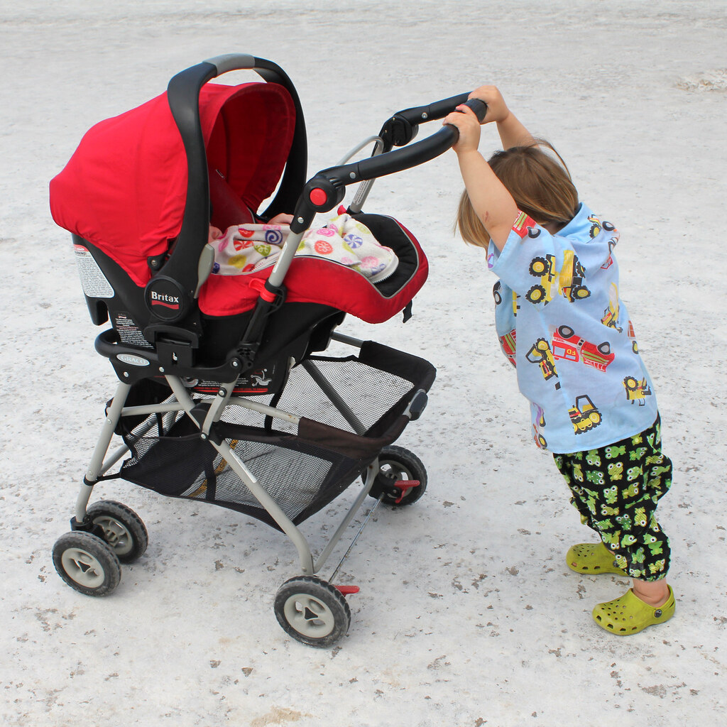 Photo of a child pushing a pram