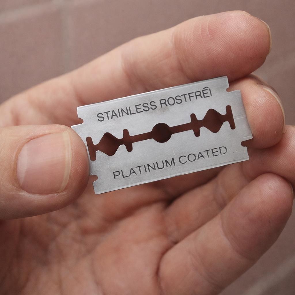 Photo of someone holding a razor blade