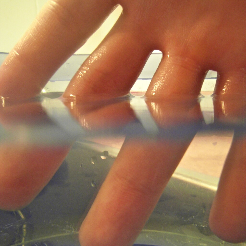 Photo of fingers diffracted in water