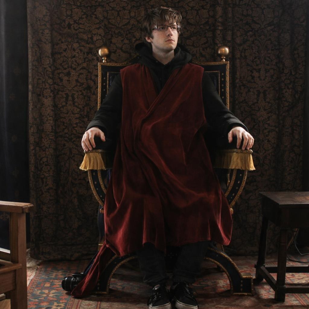 Photo of a man sitting on a throne