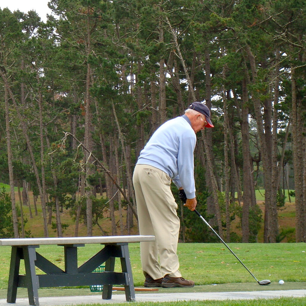 Photo of an older man playing golf