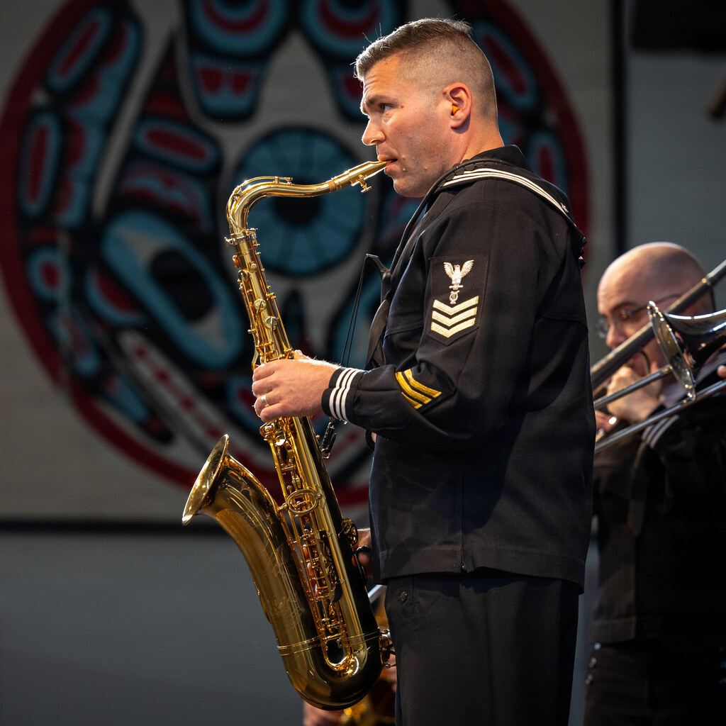 Photo of a man playing a saxophone