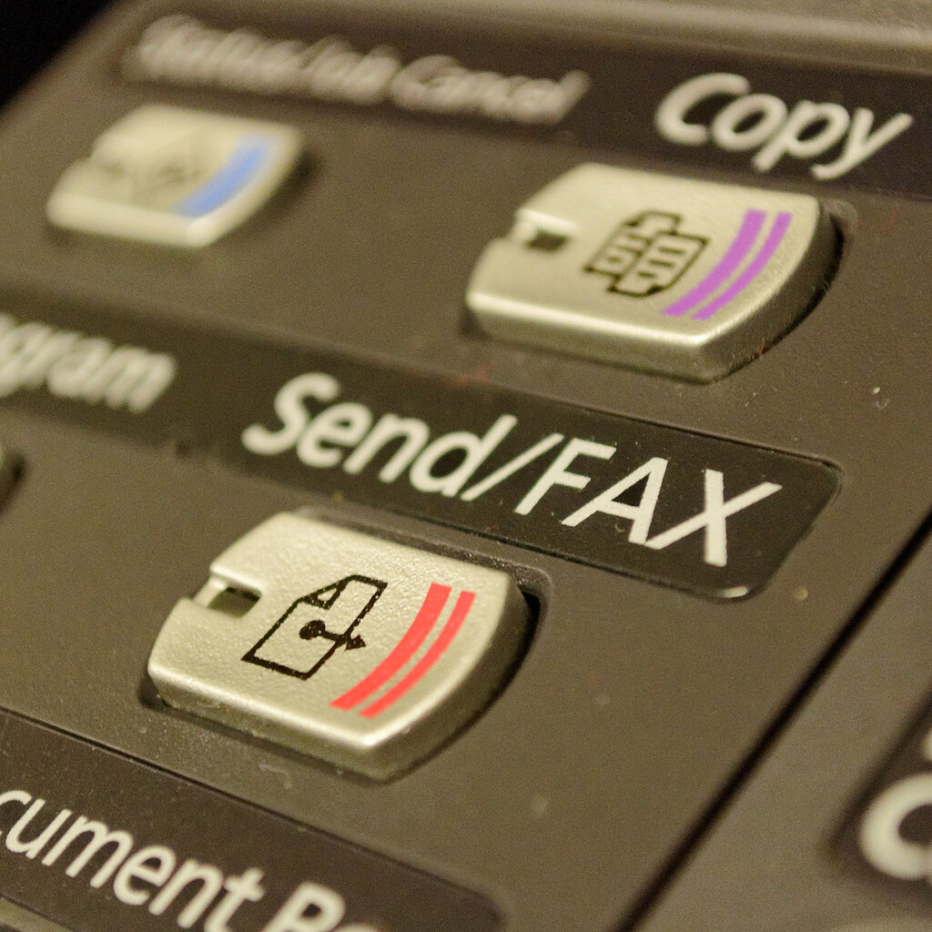 Photo of the send button on a fax machine