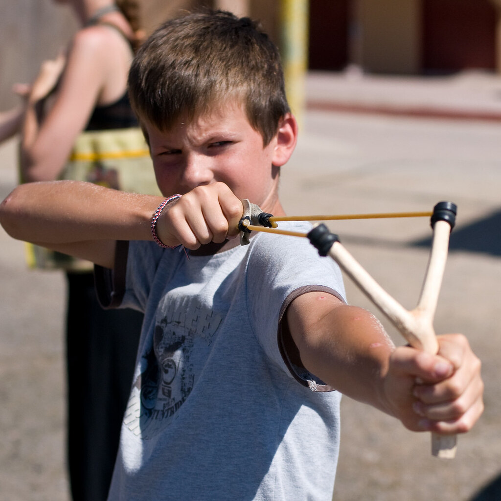 Photo of a boy using a slingshot