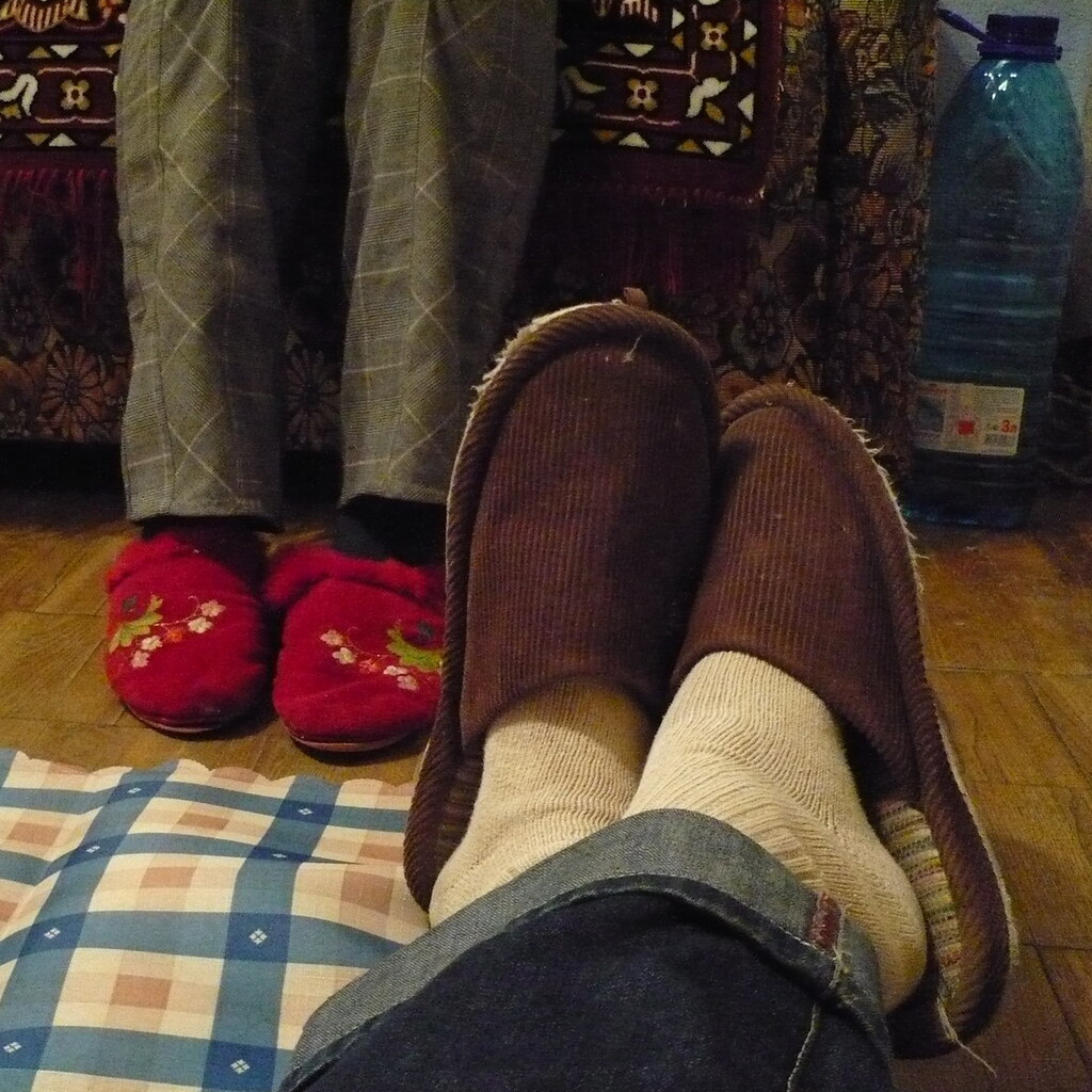 Photo of feet wearing slippers.