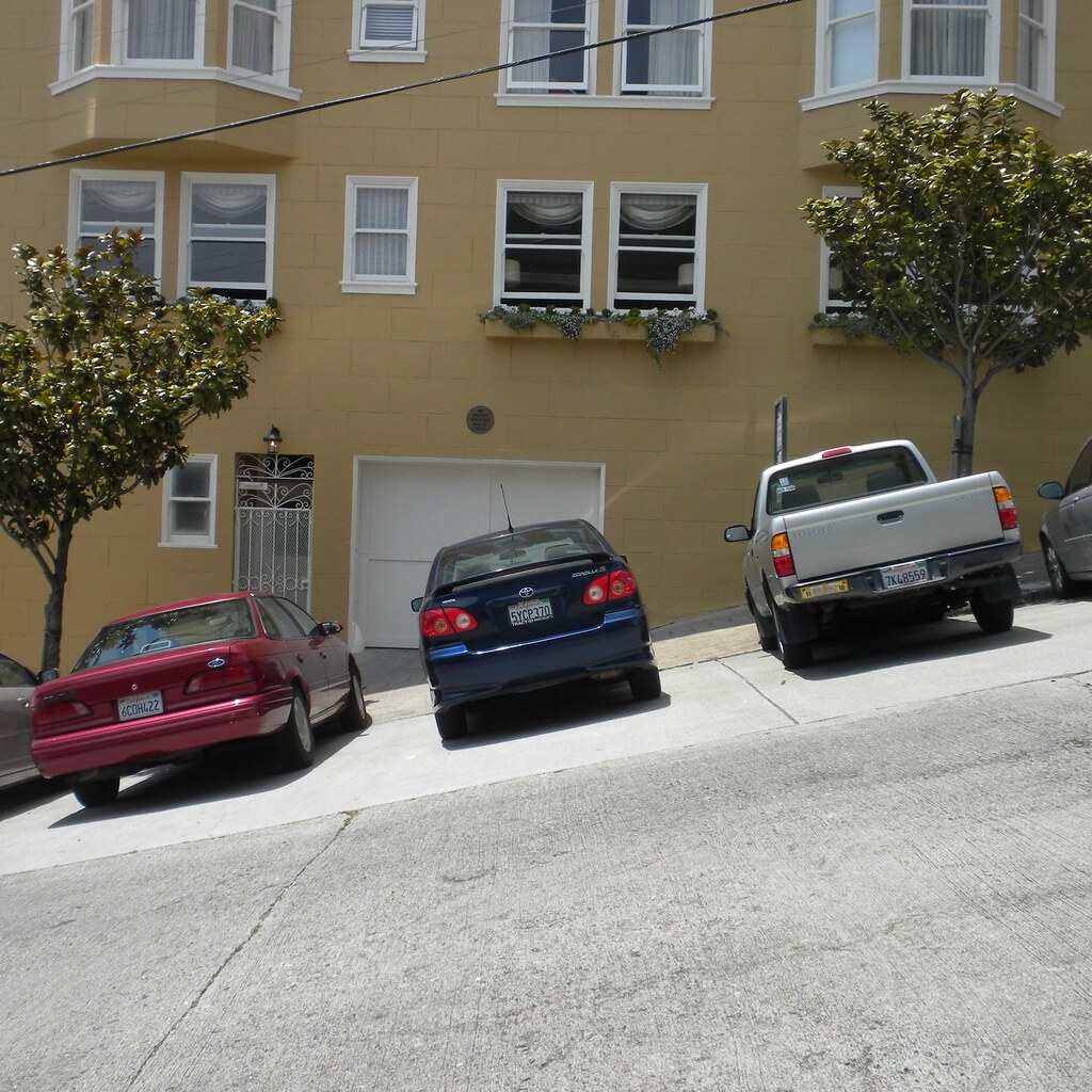Photo of cars parked on a slope