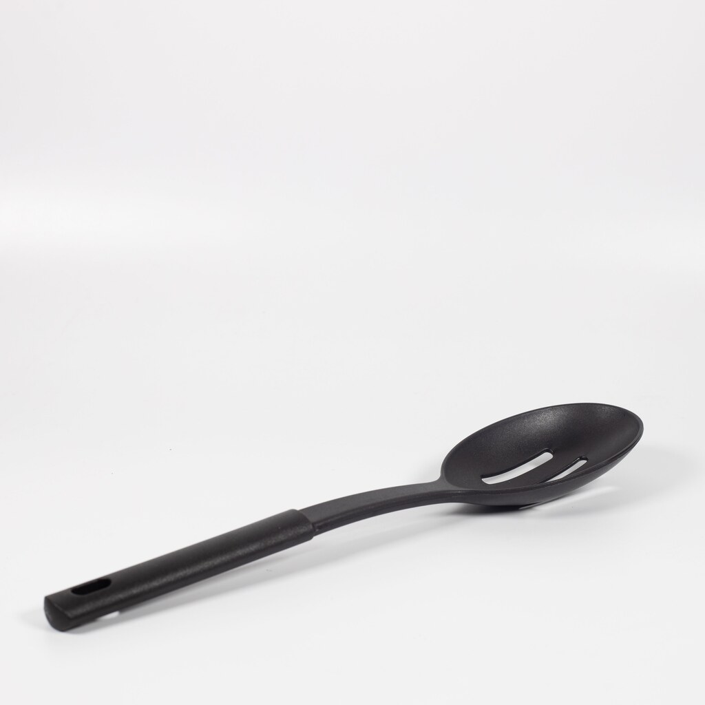 A photo of a slotted spoon