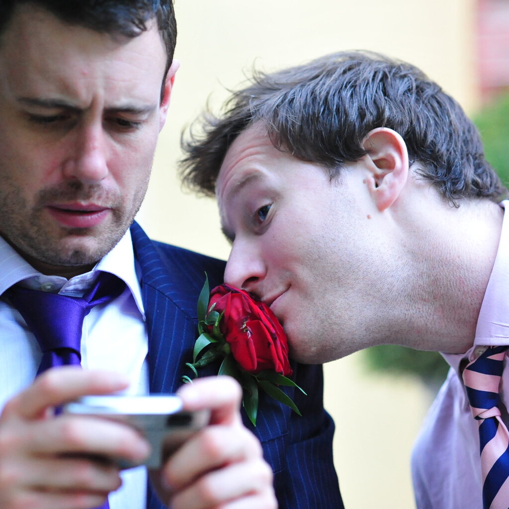 Photo of a man smelling a rose