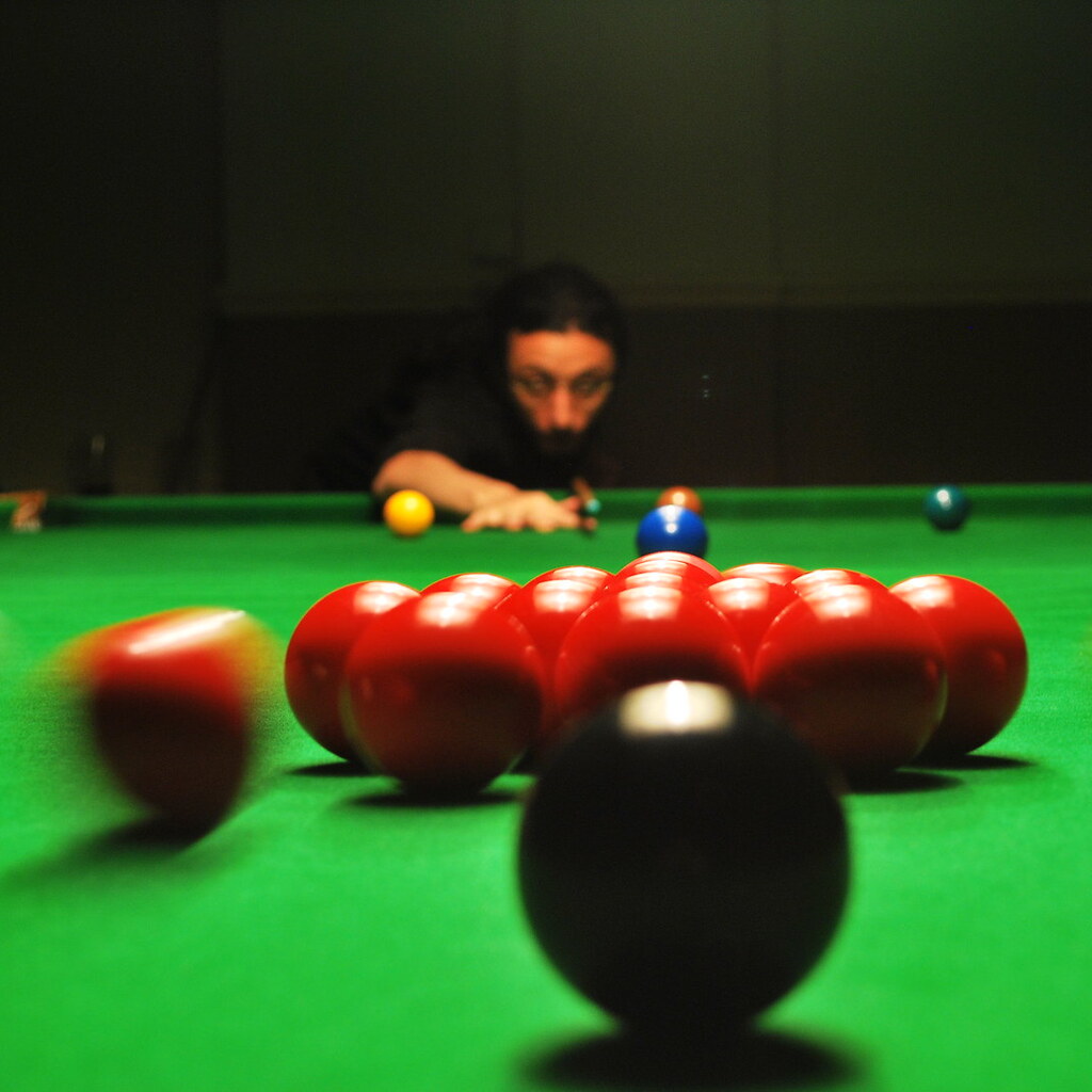 A man playing snooker.
