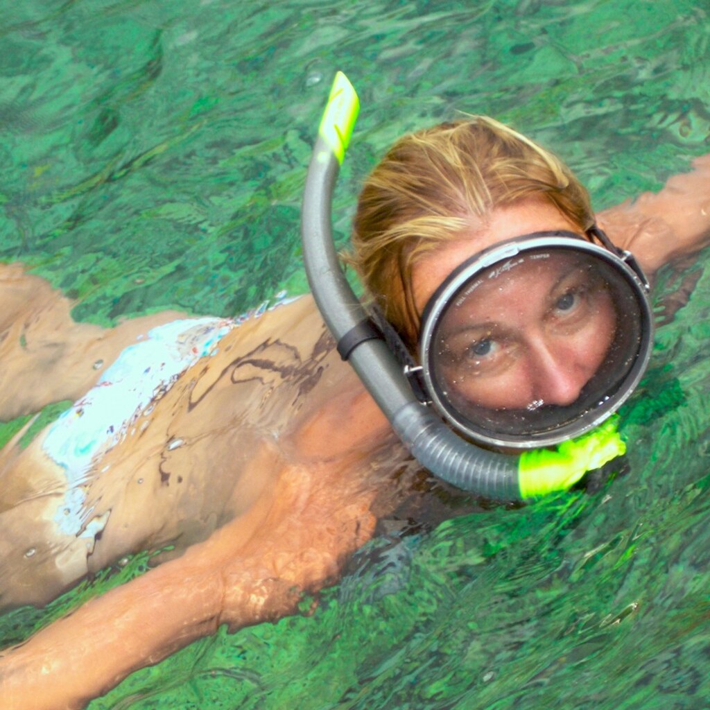 Photo of a woman swimming with a snorkel