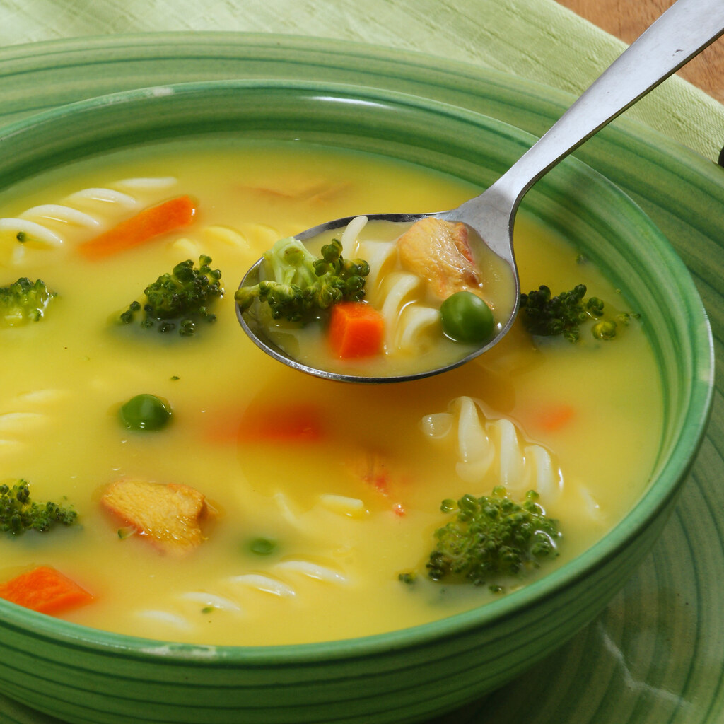 Photo of a soup spoon in a bowl of soup