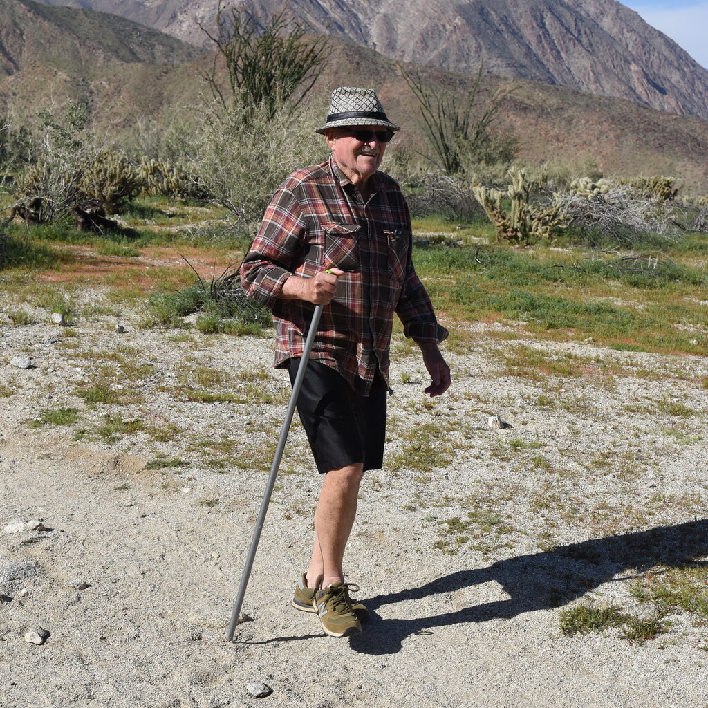 Photo of a man hiking with a staff