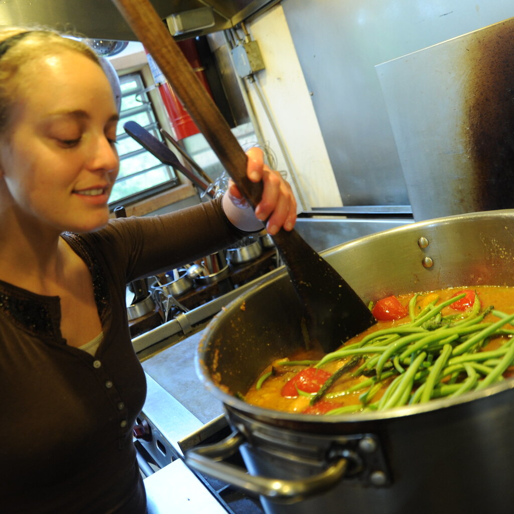 Photo of someone stirring a pot of soup