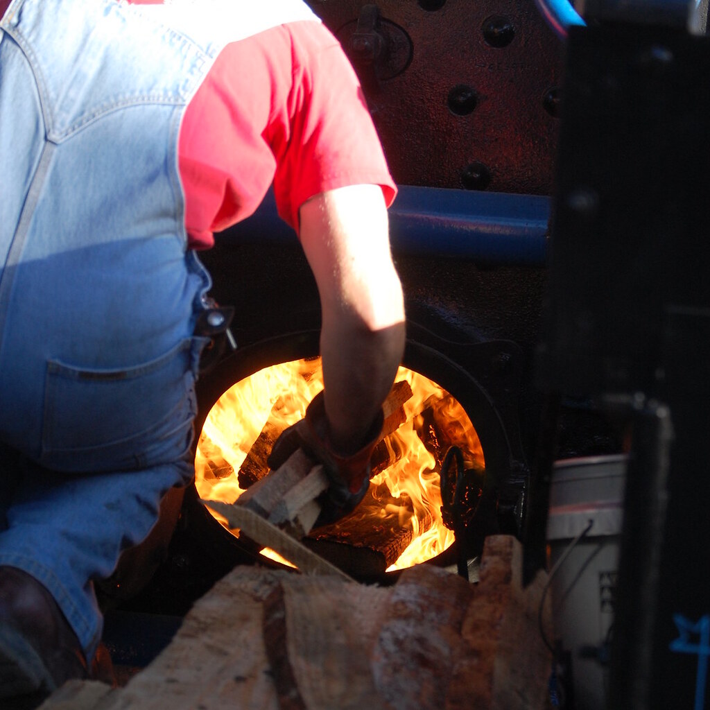 Photo of someone stoking a fire
