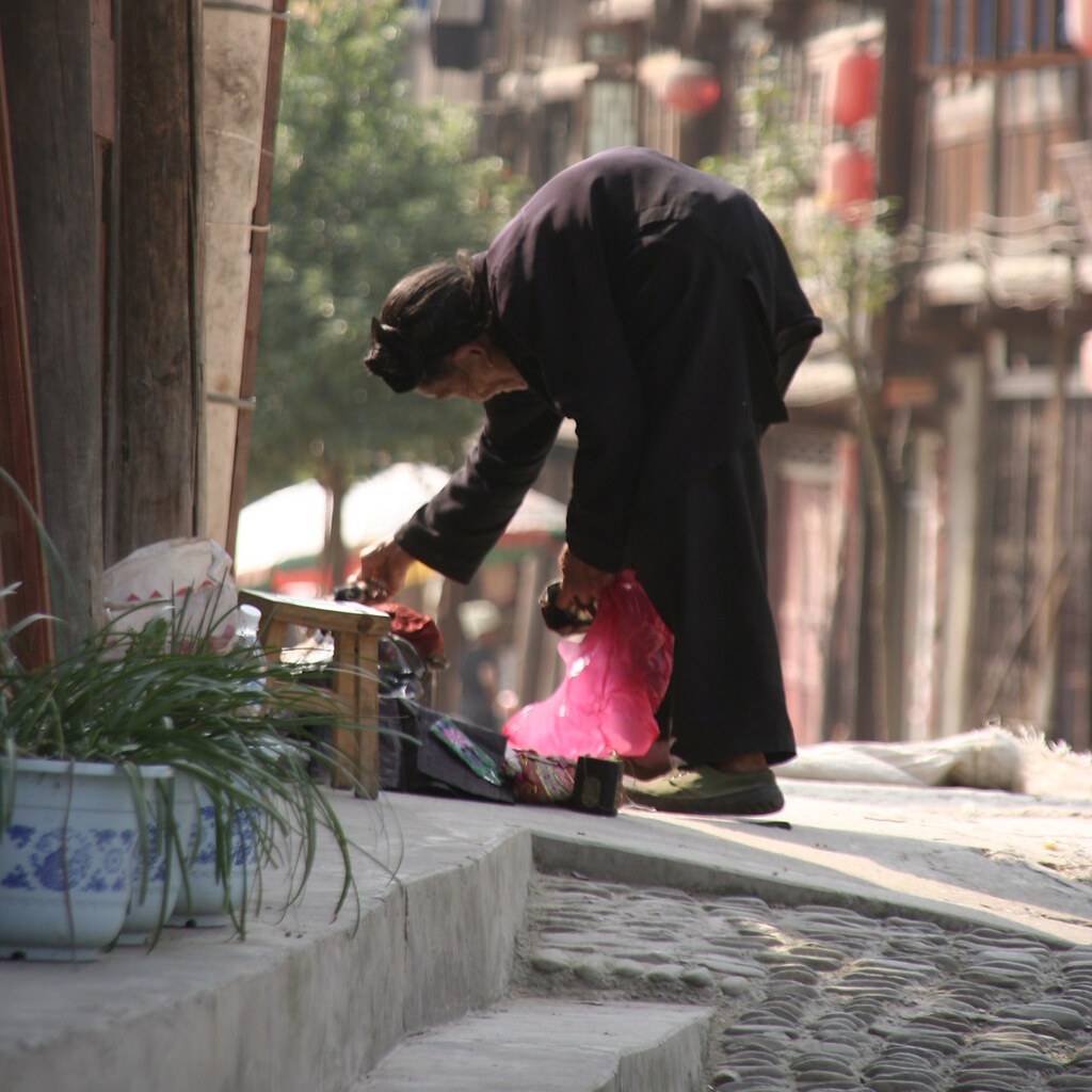 Photo of an old woman stooping