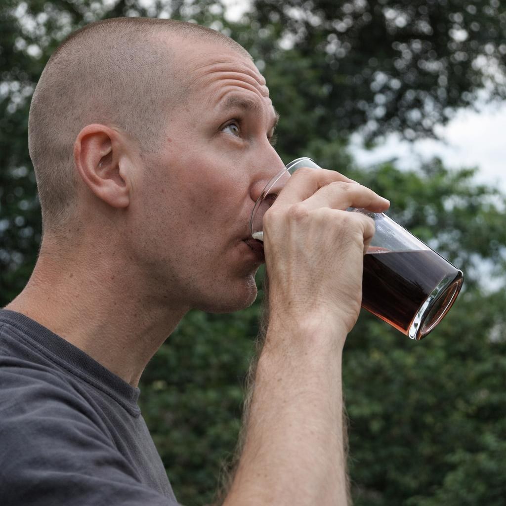 Photo of a man taking a swig of beer