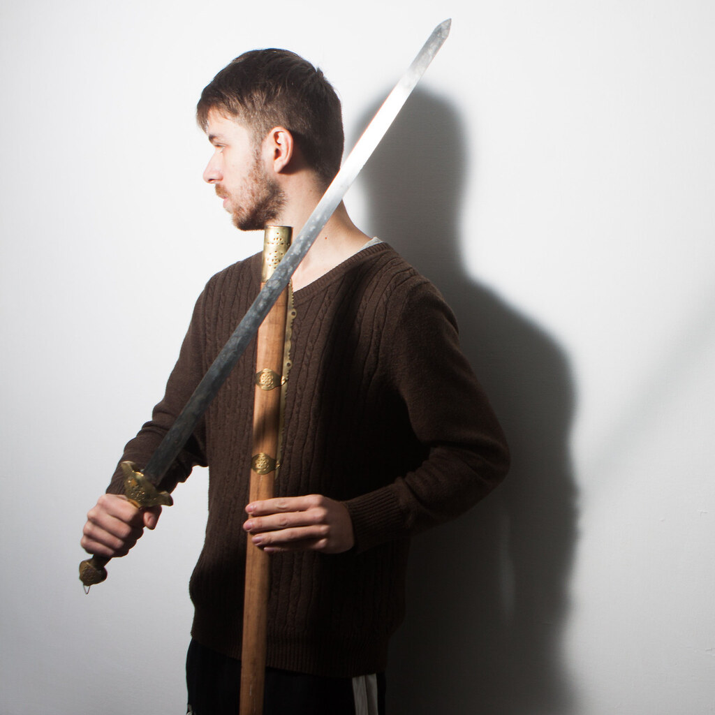 Photo of a man holding a sword