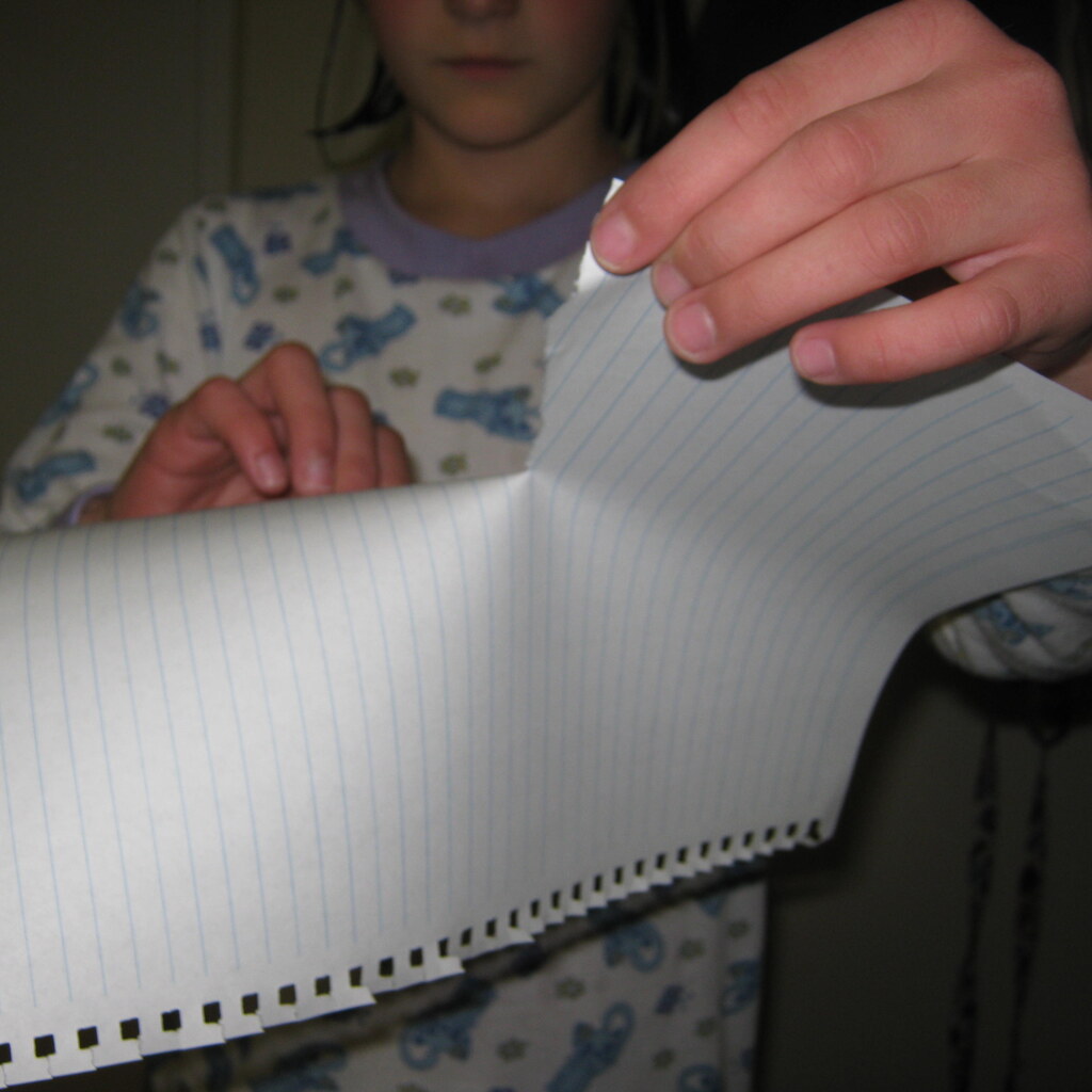 Photo of a girl tearing paper