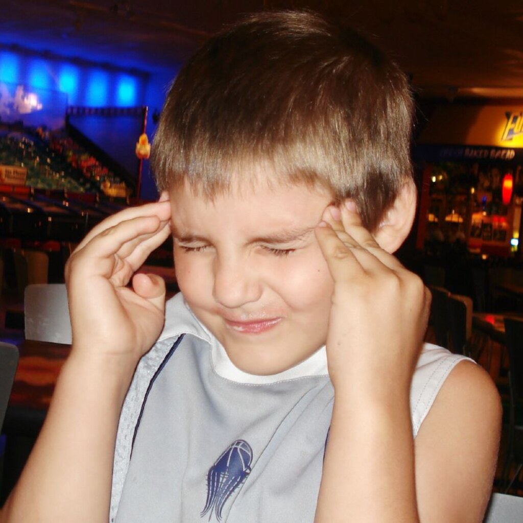 Photo of a boy pressing his temples