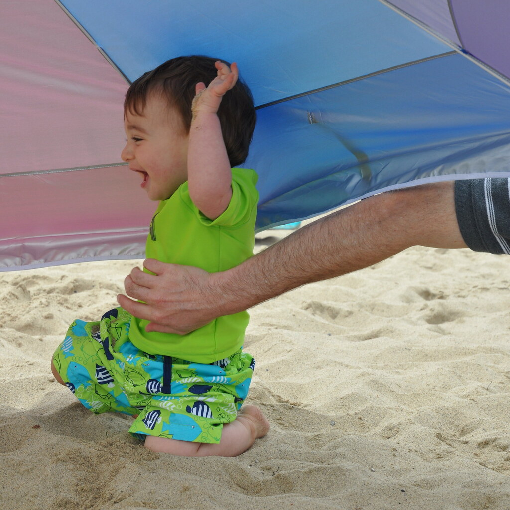 Photo of a father tickling their toddler
