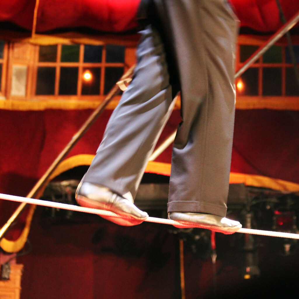 Photo of someone walking on a tightrope