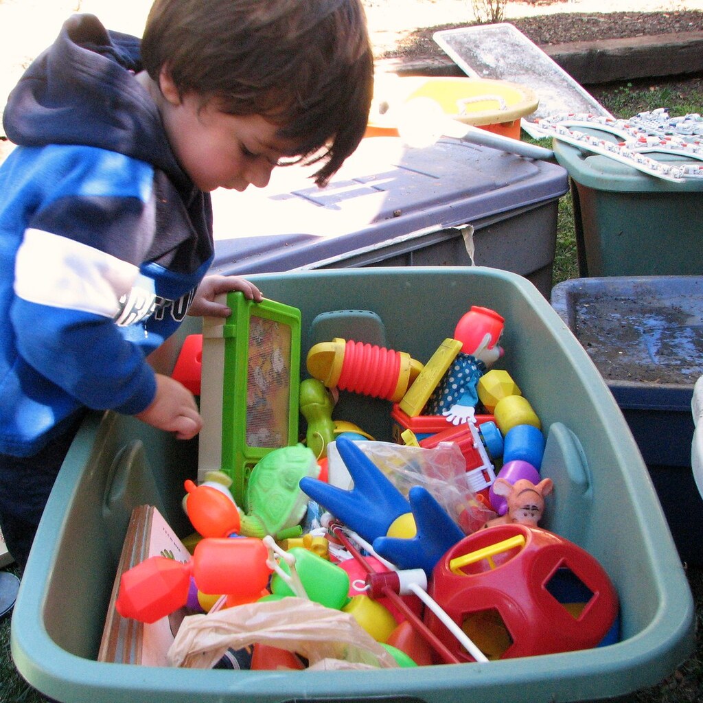 Photo of a child with a box of toys