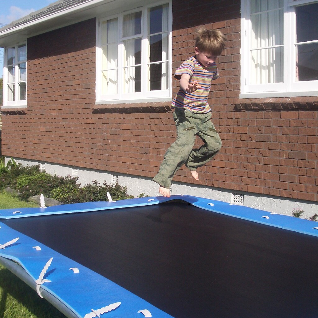 Photo of a boy jumping on a trampoline