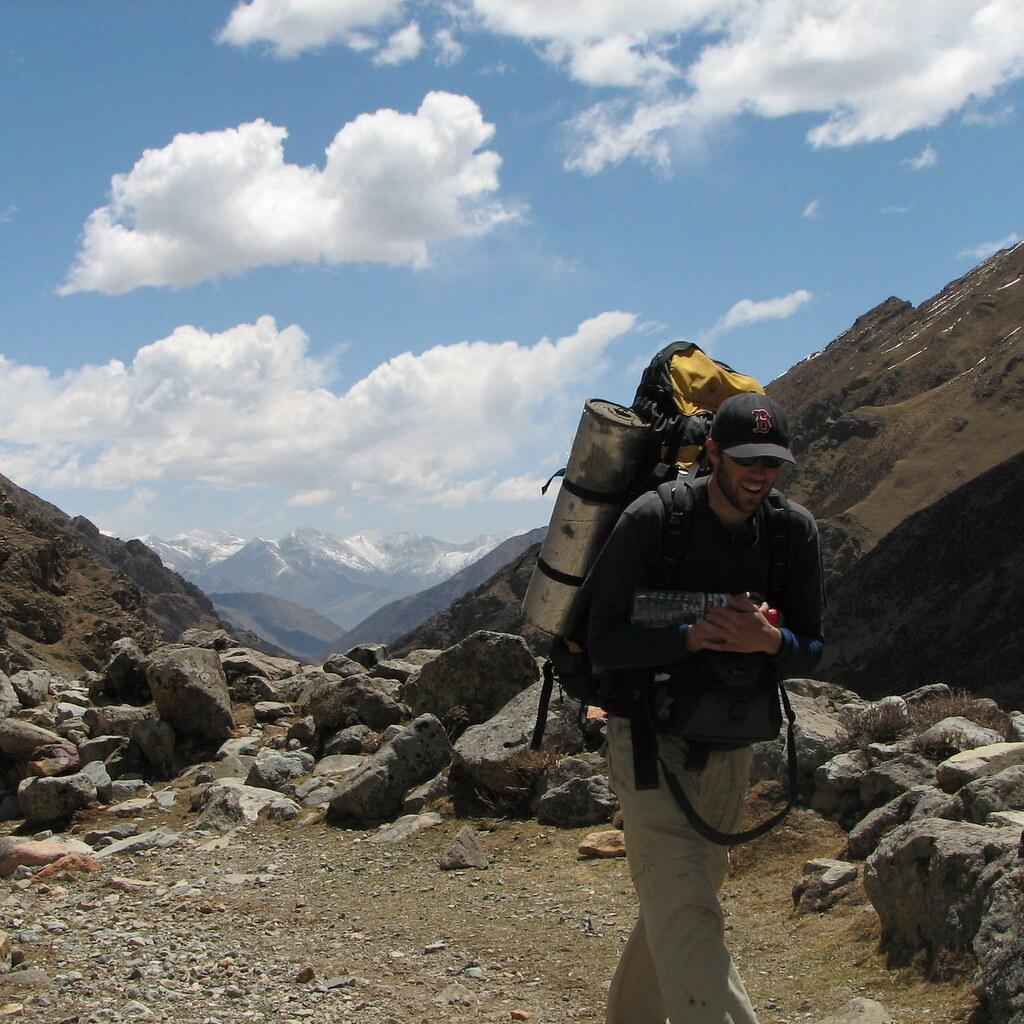 Photo of a man trekking through the mountains