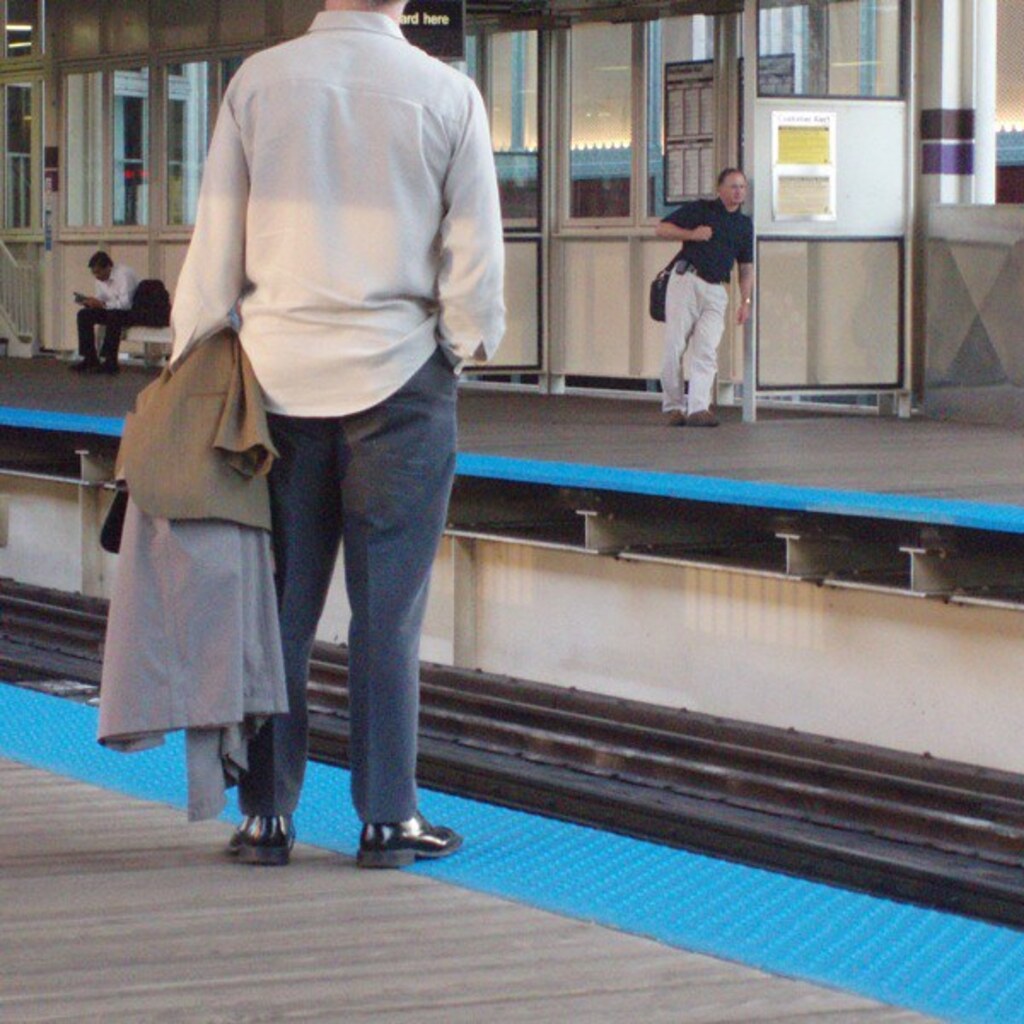 Photo of a man with his shirt untucked