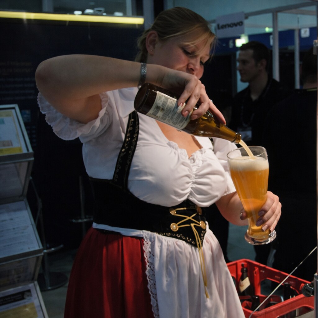 Woman dressed as a wench, serving beer.