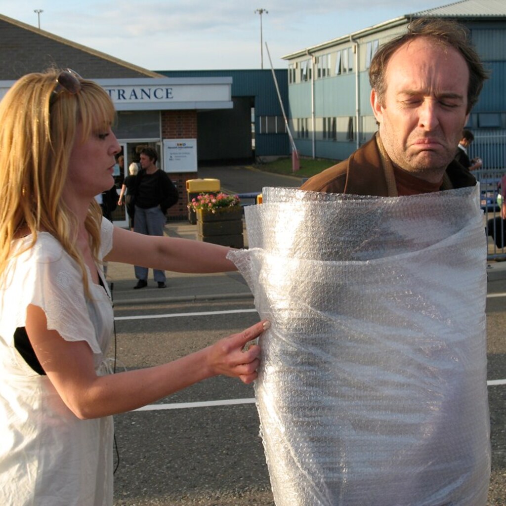 Photo of a man being wrapped up.