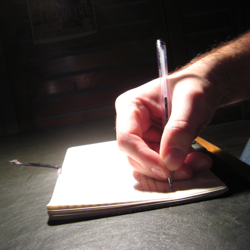 Photo of a hand writing.