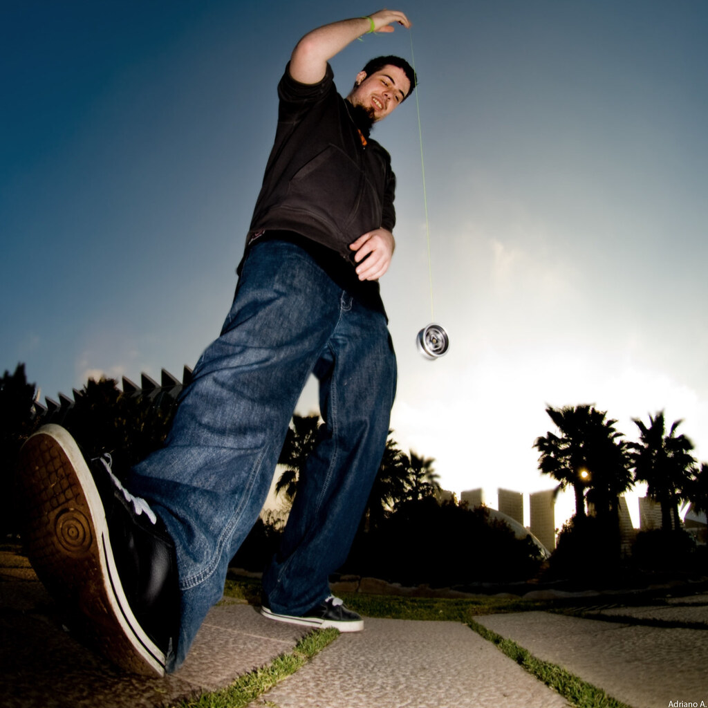 photo of a man playing with a yoyo